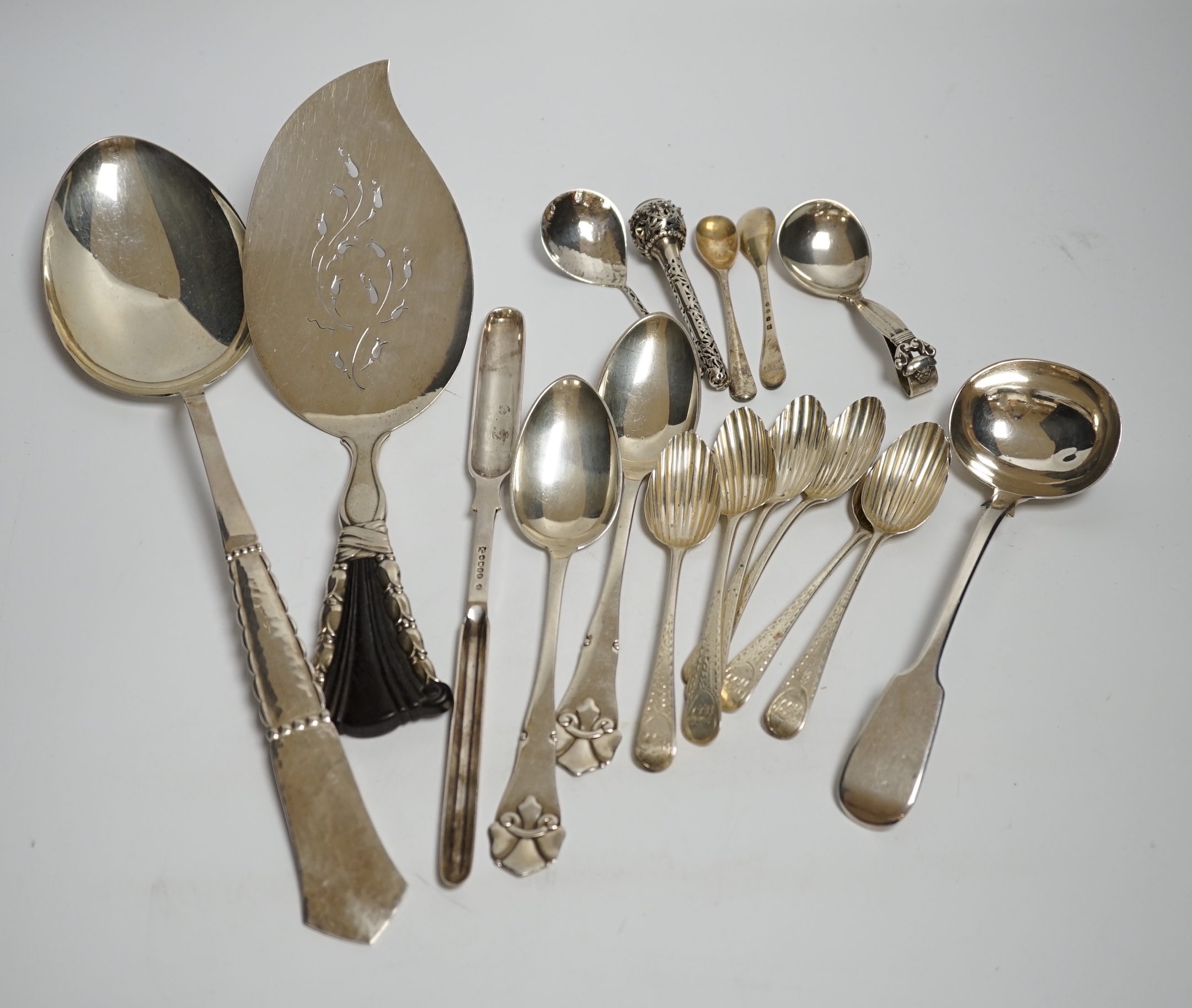 An early to mid 20th century Georg Jensen sterling and hardwood server, 26.1cm and a similar caddy spoon, together with other silver flatware, Scandinavian flatware and a plated marrow scoop.